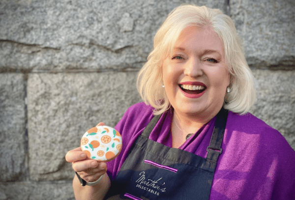 A woman holding a cookie in her hand.